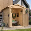 A wooden garden shed filled with gardening tools and equipment. Produktbild-Vorschau