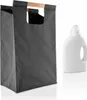 A dark gray laundry bag with wooden handles and a white bottle of laundry detergent are displayed against a white background. Produktbild-Vorschau