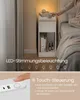 A person's hand is shown interacting with a bedside table that has LED lighting and USB ports. The image also includes text describing features. Produktbild-Vorschau