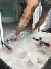 A person is using a level to install a door frame or threshold. Produktbild-Vorschau