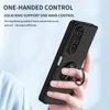 A hand holding a black phone case with a ring holder. Produktbild-Vorschau