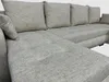 A close-up view of a beige sectional sofa. Náhled obrázku produktu