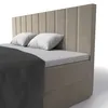 A close-up view of a beige box spring bed with white pillows and a dark gray blanket. Produktbild-Vorschau