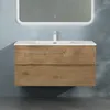 A wall-mounted bathroom vanity with a sink and faucet, set against a textured blue wall. Produktbild-Vorschau