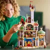 A woman is building a detailed LEGO castle, which appears to be from Beauty and the Beast. Produktbild-Vorschau