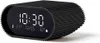 A digital alarm clock with a black ribbed casing and a white LED display showing the time, date, temperature, and humidity. Podgląd zdjęcia produktu
