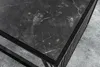 Close-up of a modern coffee table with a dark marble top and a black metal frame. Produktbild-Vorschau