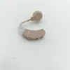 A beige and clear hearing aid is placed on a white surface. Produktbild-Vorschau