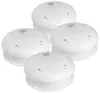 A group of four white smoke detectors are arranged in a cluster against a white background. Produktbild-Vorschau