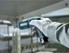 A person wearing gloves is using a cordless screwdriver to tighten a bolt on a metal shelf. Podgląd zdjęcia produktu