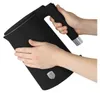 Hands holding a black electric kettle. Náhľad obrázku produktu
