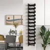 A dining area with a table, chairs, and a wine rack mounted on the wall. Náhled obrázku produktu