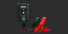 A NOCO GENIUS1 battery charger with red and black clamps against a dark background. Podgląd zdjęcia produktu