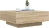 A square coffee table with a wood grain finish is shown against a white background. A small potted plant and a teacup are placed on top of the table. Náhľad obrázku produktu