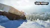 A large truck is stuck in deep snow on a snowy mountain road, with a forest and buildings in the background. Produktbild-Vorschau