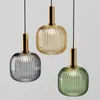 Three pendant lights of different colors (gray, yellow, green) hanging against a light gray background. Anteprima dell’immagine prodotto