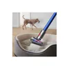 A dog is walking in the background while a vacuum cleaner head is cleaning a dog bed. Náhled obrázku produktu