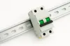 A close-up shot of a circuit breaker mounted on a metal DIN rail against a white background. Produktbild-Vorschau