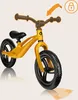A yellow balance bike with black wheels and handlebars, shown from a front-diagonal angle. Produktbild-Vorschau