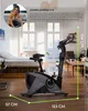 A stationary bicycle is shown in a room with a bed and furniture, with a person's image and text in the upper left corner. Produktbild-Vorschau