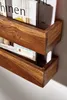 A close-up view of a wooden magazine rack with magazines inside. Produktbild-Vorschau