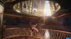 A person is performing a parkour move in a grand, opulent interior with a large staircase and balconies. Produktbild-Vorschau