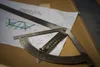 A close-up view of a protractor and ruler on top of papers with technical drawings and calculations. Produktbild-Vorschau