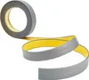 A roll of gray self-adhesive trim tape with a yellow backing is shown unrolling against a white background. Náhľad obrázku produktu