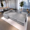 A modern living room with a large sectional sofa, dining table and chairs, and a potted tree. Produktbild-Vorschau
