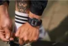 A person is tying their shoelaces, showing off a watch on their wrist. Produktbild-Vorschau