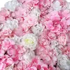 A close-up view of a wall of artificial pink and white flowers. Voir les images du produit