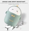 A cartoon-style trash can shaped like a duck is shown falling and cracking the ground, illustrating its durability. Produktbild-Vorschau