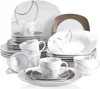A collection of white ceramic dinnerware with a brown abstract design, arranged in a studio setting. Náhled obrázku produktu