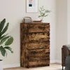 A tall, narrow chest of drawers with a rustic wood finish is placed in a room next to a large potted plant. A framed picture hangs on the wall above the chest, and a small radio and books sit on top. Anteprima dell’immagine prodotto