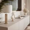 A modern living room setup featuring a TV stand with decorative items. Produktbild-Vorschau