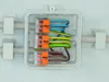 A close-up view of WAGO 221-612 series lever connectors inside a white junction box, with electrical wires connected. Podgląd zdjęcia produktu