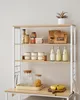 A kitchen shelf displaying various food items, jars, and a plant. Náhled obrázku produktu