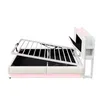 A side view of a bed with its storage mechanism open, revealing the interior space. The bed has a white upholstered frame and a pink LED light strip along the bottom. The headboard is also white and features integrated shelving and what appears to be a scr Anteprima dell’immagine prodotto