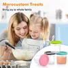 A mother and daughter are in a kitchen, preparing food. Several small food storage containers are displayed in the foreground. Produktbild-Vorschau
