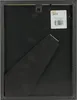 The back of a black picture frame with a stand and a label attached. Náhled obrázku produktu