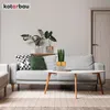 A living room scene with a sofa, coffee table, and plants. Podgląd zdjęcia produktu