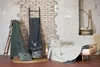 A collection of blankets and pillows with a 'be wild' deer motif, arranged in a rustic bedroom setting. Produktbild-Vorschau