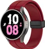 A close-up studio shot of a smartwatch with a red strap. Produktbild-Vorschau