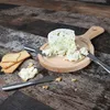 A cheese board with cheese and crackers on a wooden table. Produktbild-Vorschau