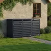 Three dark gray trash can enclosures are lined up in front of a brick wall with a window. Green ivy hangs from the top left, and grass and a stone path are in the foreground. Produktbild-Vorschau