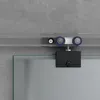 A close-up view of a sliding glass door mechanism against a concrete wall. Produktbild-Vorschau