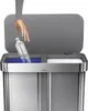A hand is shown dropping a plastic bottle into a recycling bin. Podgląd zdjęcia produktu