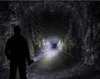 A person with a flashlight in a dark tunnel. Podgląd zdjęcia produktu