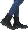 A person wearing blue jeans and black boots. Produktbild-Vorschau