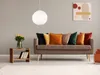 A living room scene with a sofa, side table, and artwork. Náhled obrázku produktu